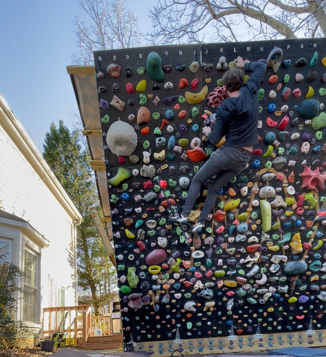 A climber near the top of the backyard wall